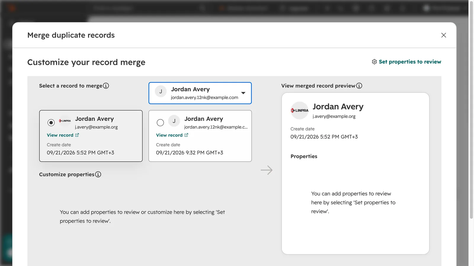 HubSpot&rsquo;s Merge duplicate records dialog with two Jordan Avery contacts side by side and a preview of the merged record