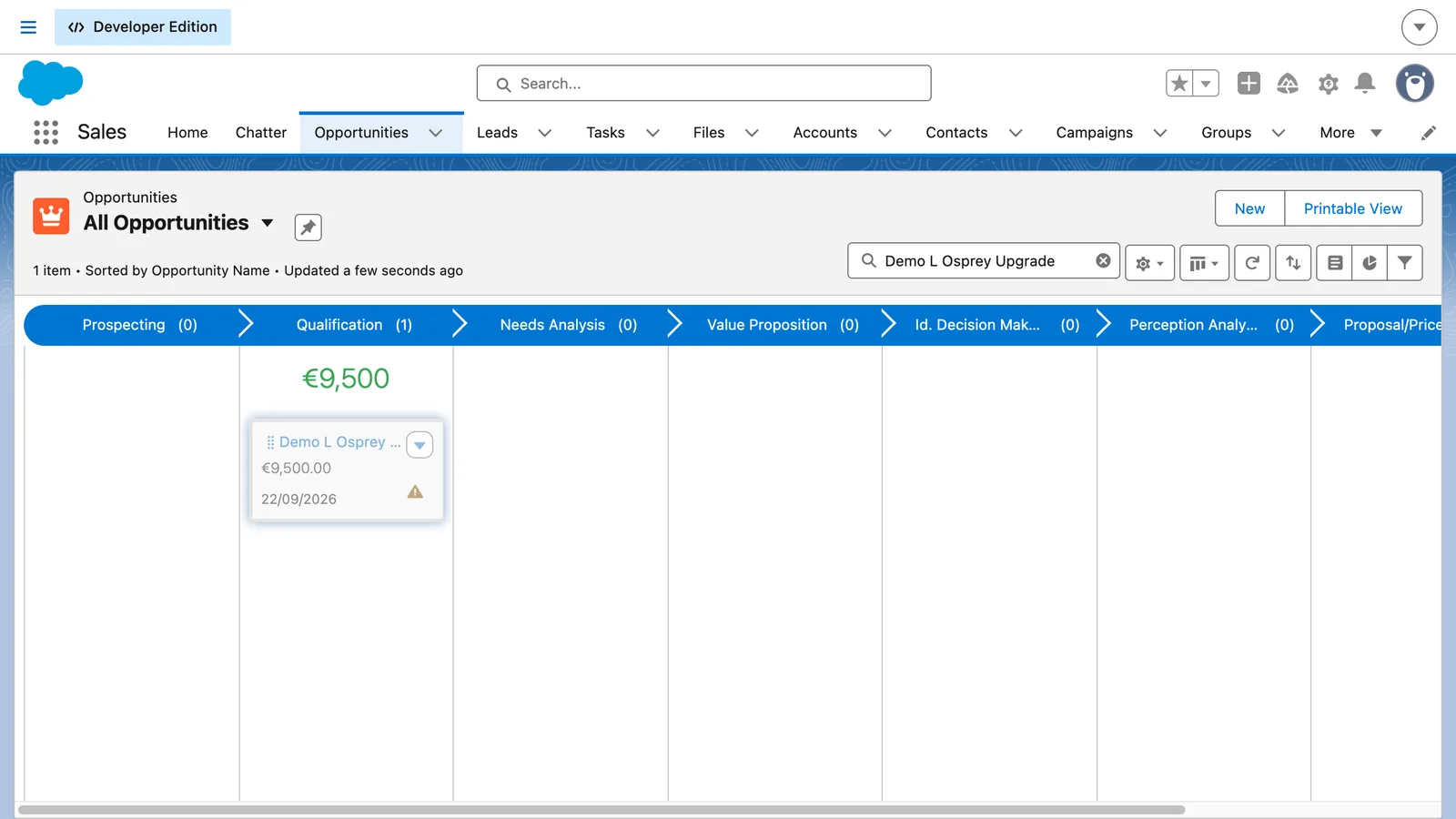 Salesforce screen from the video: Drag the card to the next stage to update the opportunity.