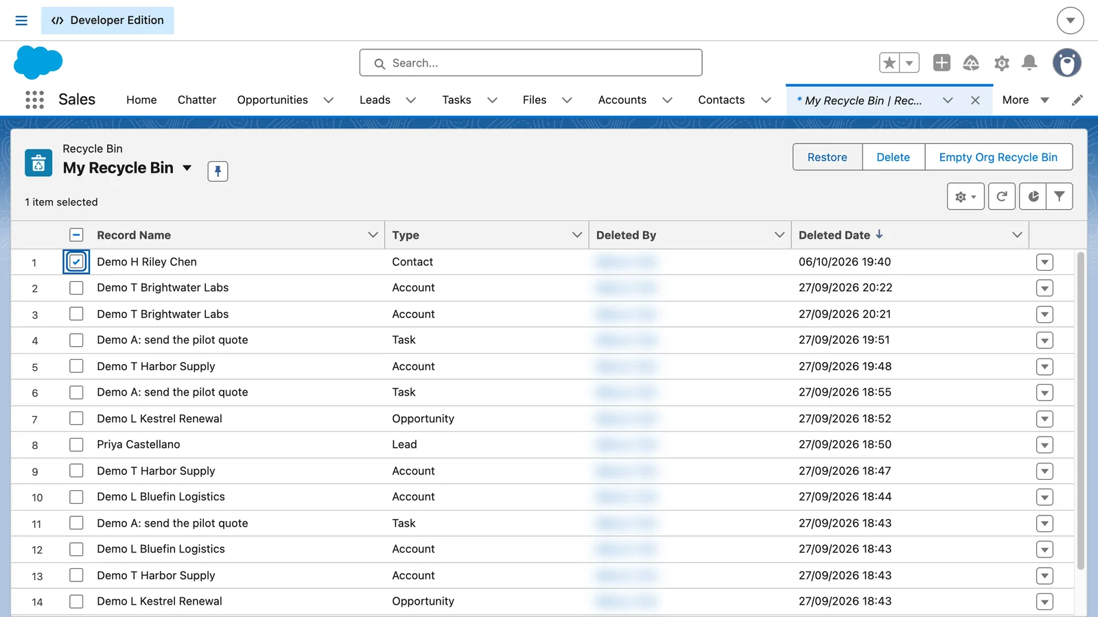 Salesforce screen from the video: Select the demo contact, then click Restore.